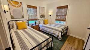 Una cama o camas en una habitación de Chic Central Bungalow close to VSU and Hospital, Game Room, 3 TVs & Fire Pit