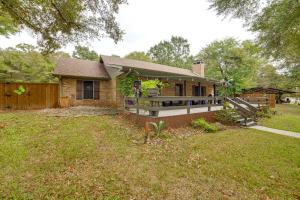 a brick house with a fence and a yard at Walk to Lake Athens! Updated Home with Large Deck in Murchison