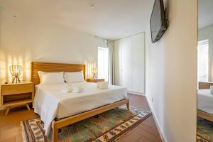 a bedroom with a bed and a tv on a wall at Private Villa T8 - Casa Da Bra Viana Do Castelo in Viana do Castelo +245 photos