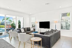 a living room with a couch and a tv at LC517T The Chic Abode at Liberty Bluff in Kissimmee