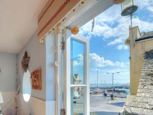 a door to a building with a view of a harbor at Seaside in Lyme Regis