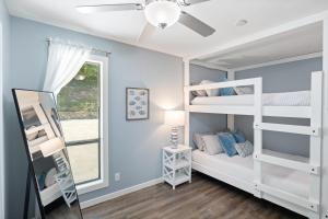 a bedroom with two bunk beds and a window at Walk to The Strip! Great Cove Water for Lake Fun in Lake Ozark +45 photos