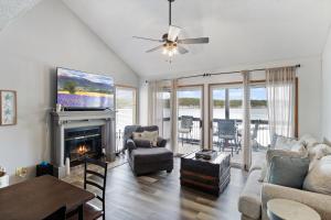 a living room with a couch and a fireplace at Poolside Condo with Amazing Lake Views & Design in Damsel +39 photos