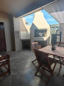 a kitchen with a table and chairs and a large window at SUNSET Self-Catering Eco Guesthouse in Brandvlei