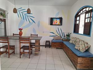 a living room with a couch and a table at Odoyá Casa Hostel in Arraial d'Ajuda