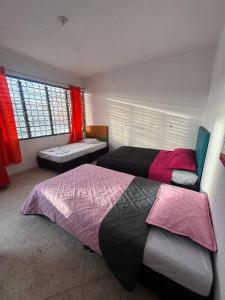 a bedroom with two beds and a window at Hostel Flandes tu sitio in Flandes +20 photos
