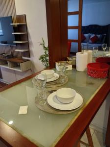 a table with plates and glasses on top of it at Danyedi Apart in Santiago