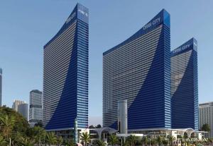 two tall buildings in a city with palm trees at VIP ORBI city A D C in Batumi