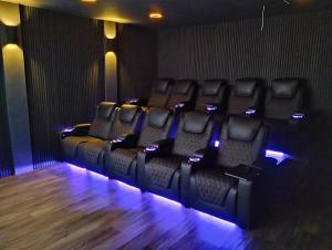 a row of empty chairs in a movie theater at Timeless-Texas-Inn - Heated Pool Oasis & Lux Vibe in Round Rock +42 photos