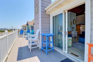 a porch with blue stools and a blue table at 5070 - Sandy Bottoms in Croatan Shores