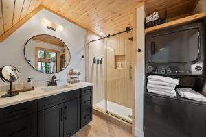a bathroom with a sink and a shower at Ascent A-Frame at Calm Ridge Treehouses in Boone +34 photos