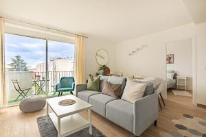 a living room with a couch and a table at Friendly and spacious apartment in Créteil ! in Créteil