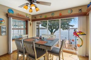 a dining room with a table and chairs and a large window at Incredible Views, Fishing, Private Dock & Slip in Laurie