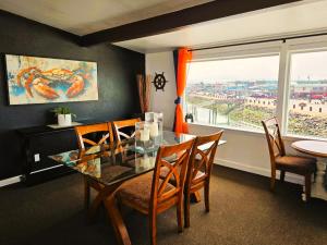 a dining room with a table and chairs and a window at Saltwater Inn in Westport