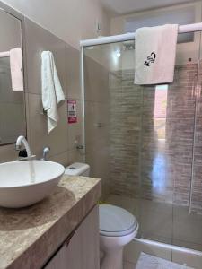a bathroom with a sink and a toilet and a shower at Residence Cumbuco Paradise Beach in Cumbuco
