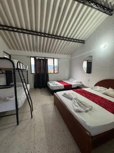 a bedroom with two bunk beds and a ceiling at Hostel Flandes tu sitio in Flandes