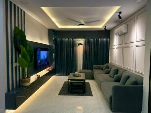 a living room with a couch and a tv at AirHomes By Zameen Opal in Lahore
