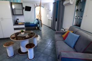 a living room with a couch and a table at Cogo House in Cogoleto