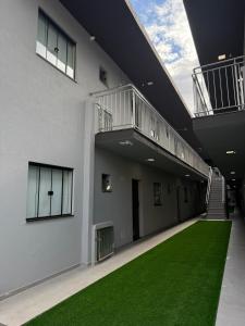 an empty hallway with green grass in a building at Studio47 - Compact, equipped and well located in Itajaí