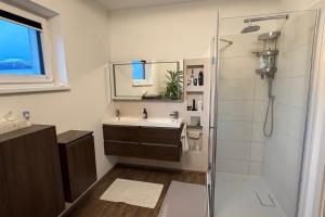 a bathroom with a shower and a sink at Modern House in Spielberg near Red Bull Ring in Spielberg