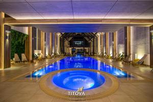 a large swimming pool in a building with blue water at Royal apartman Zlatibor in Palisat