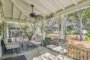 a porch with chairs and a ceiling fan at Sans Souci by 30A Escapes in Seacrest