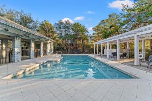 a swimming pool in the backyard of a house at Sans Souci by 30A Escapes in Seacrest