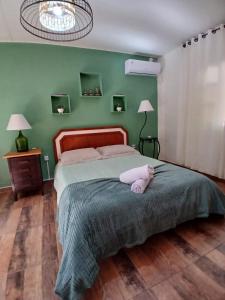 a bedroom with a bed with a stuffed animal on it at Canto da Cachoeira relaxe ao som das águas in Tijucas +54 photos