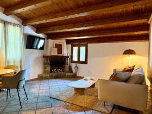 a living room with a couch and a fireplace at Casa Petra in Morillo de Monclús