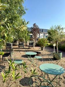 a group of tables and chairs in a yard at Villa Botanica in Odargowo