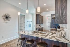 kuchnia z blatem i stołkami w obiekcie Sandy Toes by 30A Escapes w mieście Rosemary Beach