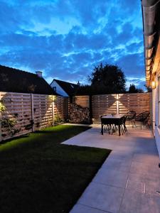 a patio with a table and chairs in a backyard at vakantiewoning 266 in De Panne