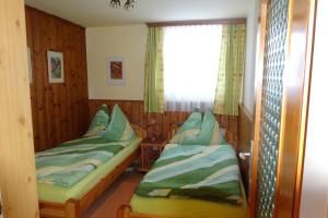 a room with two beds and a window at Haus Dreier in Abtenau