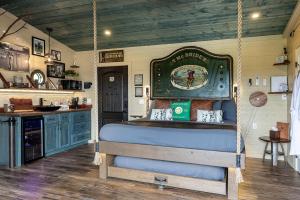 a bedroom with a swing bed in a house at "The 19th Hole" Luxury Treehouse w Golf Views & Private 20ft Slide - 10 Miles from Dollywood in Catlettsburg