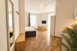 a living room with a bed and a table at LUMA Apartments in Dresden