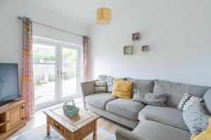 a living room with a couch and a tv at Fife coastal corner in Buckhaven