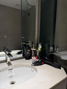 a bathroom counter with a sink and a mirror at AirHomes By Zameen Opal in Lahore +29 photos