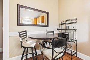 a dining room with a table and chairs and a mirror at Big Yellow in Indianapolis
