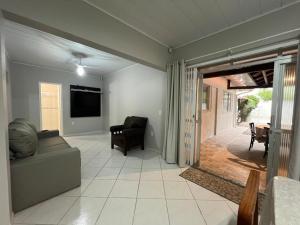 ein Wohnzimmer mit Couch und Flachbildfernseher in der Unterkunft Residencial Elsa Tarcila in Bombinhas