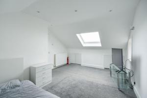 a white bedroom with a bed and a skylight at Fife coastal corner in Buckhaven +12 photos