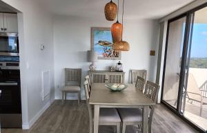 a kitchen and dining room with a table and chairs at Our House at the Beach W-704 in Siesta Key
