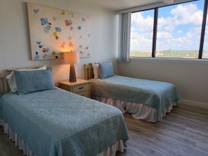 a bedroom with two beds and a window at Our House at the Beach W-704 in Siesta Key +37 photos