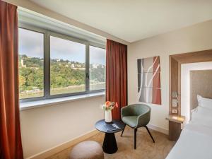 Giường trong phòng chung tại Novotel Lyon Centre-Confluence Bord de Saone