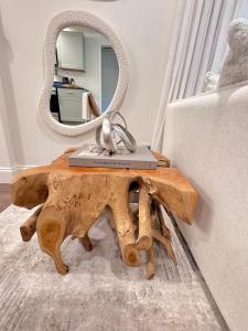 a mirror on top of a wooden table with a laptop on it at Farmhouse at Montaluce Winery-2 Restaurants- Fast WIFI-Free Park-Hike-Weddings in Dahlonega