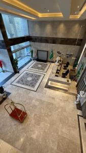 a large room with a lobby with a television at اصول الجوهرة العزيزية Asoul Al Jawhara Al Azizia in Al ‘Azīzīyah