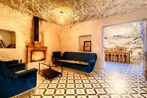 BenaguacilにあるCueva con chimenea a 20 minutos de Valenciaのソファと暖炉のあるリビングルーム