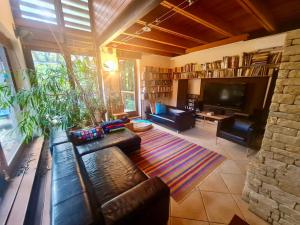 a living room with couches and a tv and a couch at Calderus house Dobogókő in Pilisszentkereszt