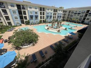 an overhead view of a swimming pool in a hotel at Centrally-Located 1BR Suite with Resort Pool View in Frisco +24 photos