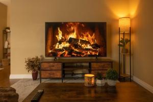 a fire in a living room with a fireplace at Mi Light House 米拉 in Yellowknife