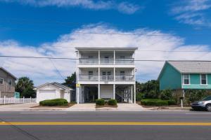 a white house with a balcony on a street at Grand View in Edisto Island
